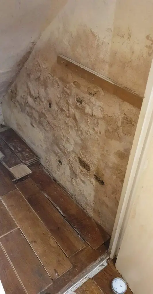 Damp floors in old houses caused by leaking pipes